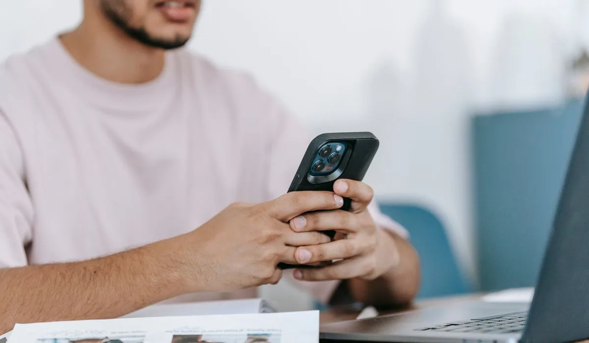 Business owner recording customer consent on a phone at a desk